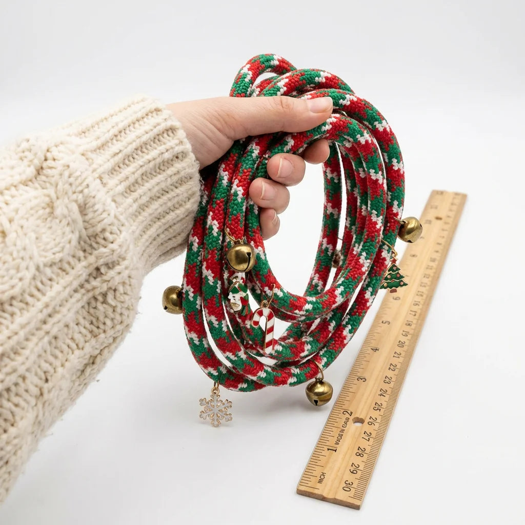 Hand holding Christmas red green braided rope dog leash showing scale and comfortable grip