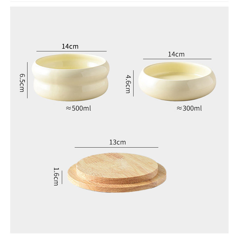 Close-up of ceramic bowls and wooden feeding stand