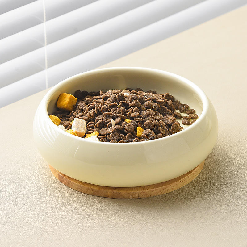 Double ceramic food and water bowl on wooden stand side angle